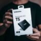 Person holding a Samsung portable SSD external drive