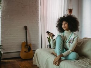 Person relaxing at home with a remote, streaming TV securely with a VPN