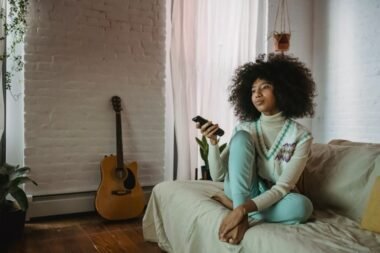 Person relaxing at home with a remote, streaming TV securely with a VPN
