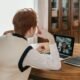 Person on a video call on a laptop using a webcam at a home desk