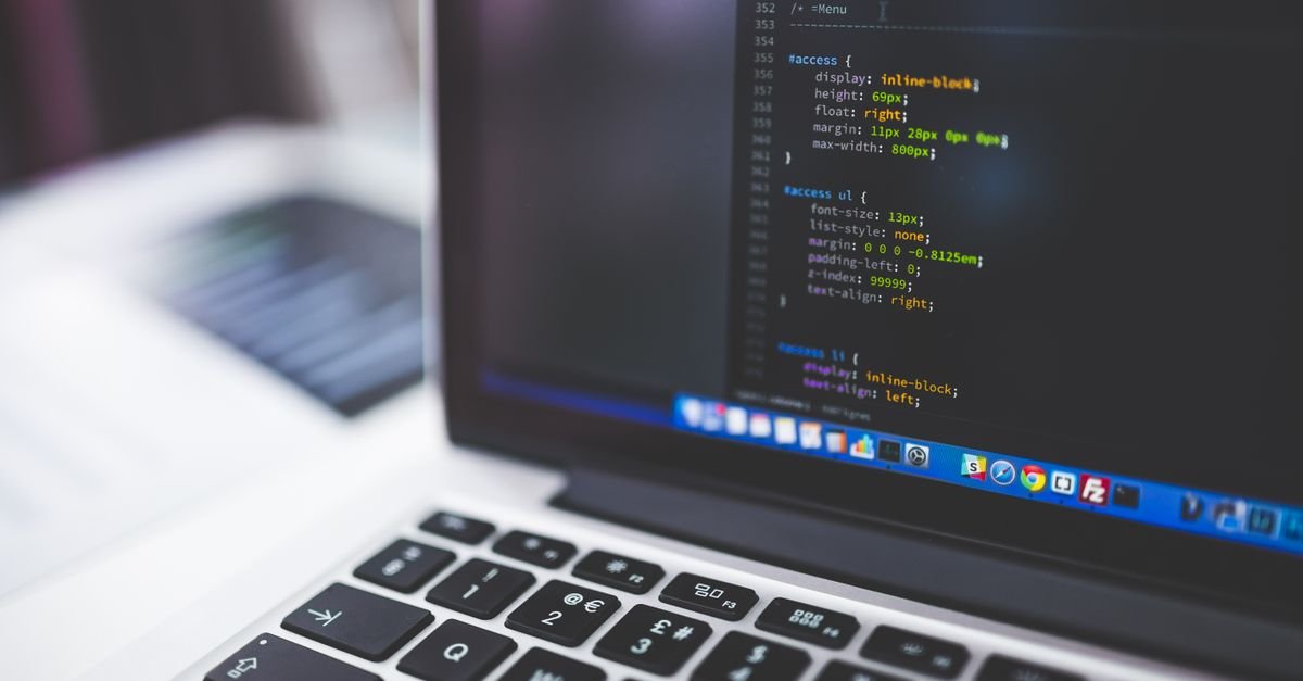 A laptop showing website code