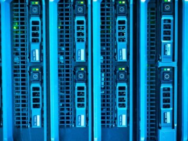 A row of server blades glowing blue in a data center