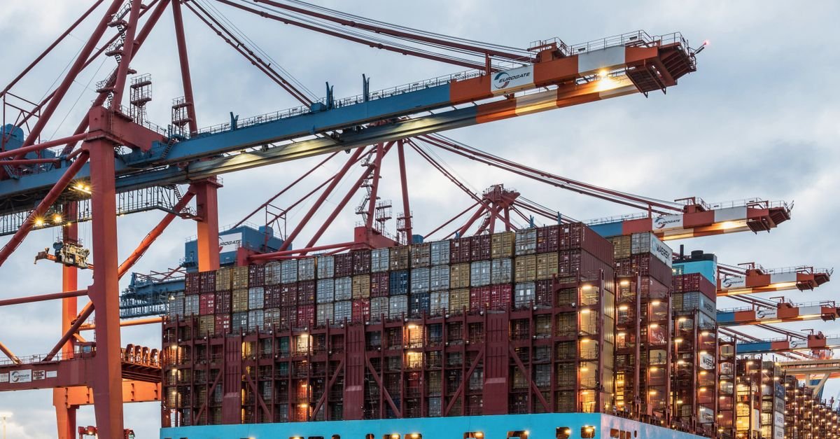 Crane loading shipping containers at a port