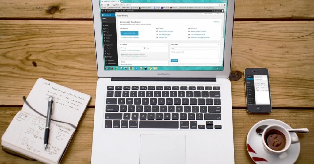 Laptop showing a web hosting dashboard while comparing managed WordPress plans