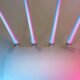 A wifi router glowing under neon pink and blue light