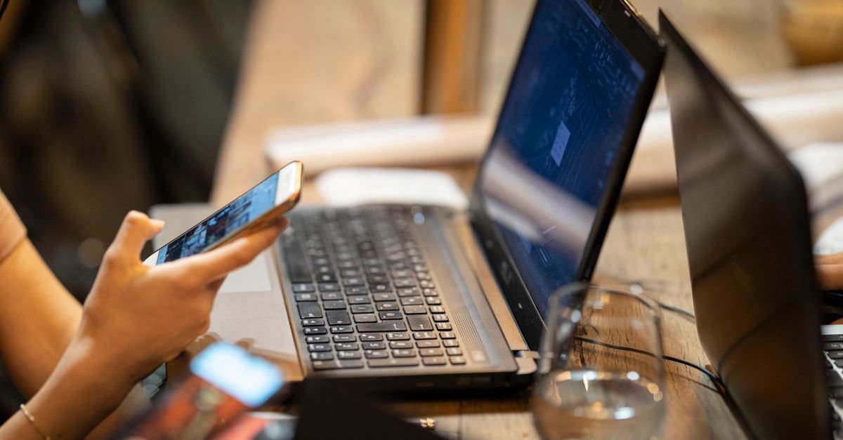 Using a phone next to a laptop to confirm a login
