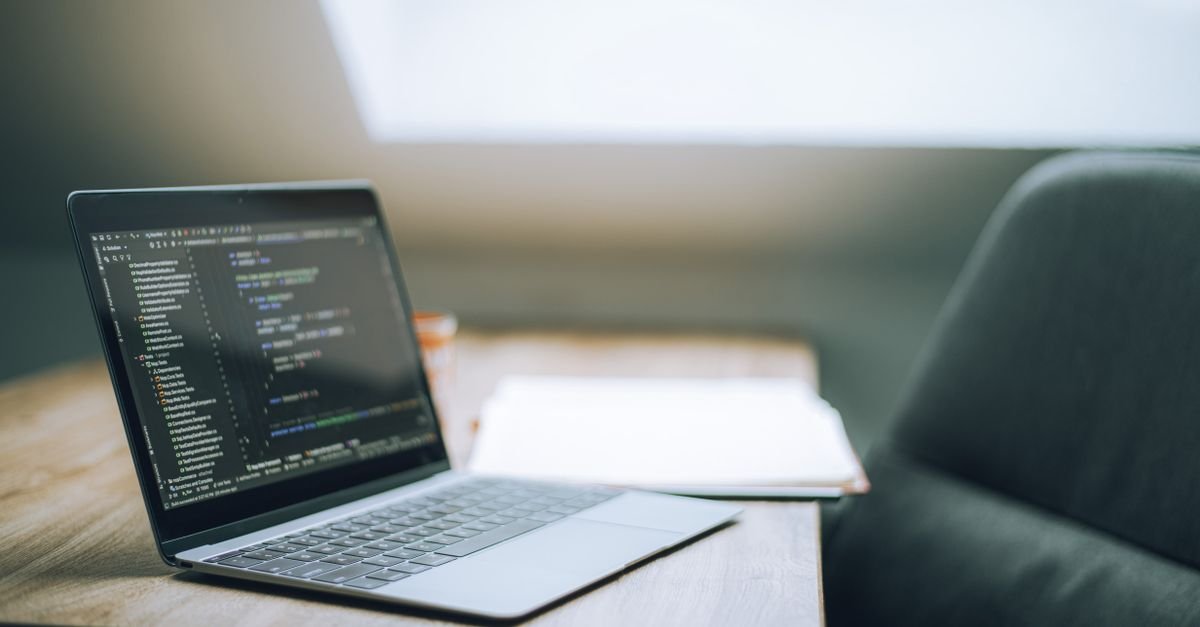 Laptop showing code on a desk