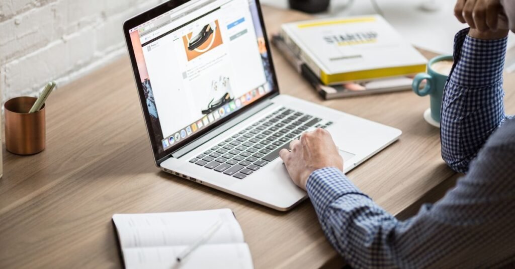 Person updating a website on a laptop