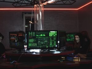 A dark security operations room with monitors showing green code