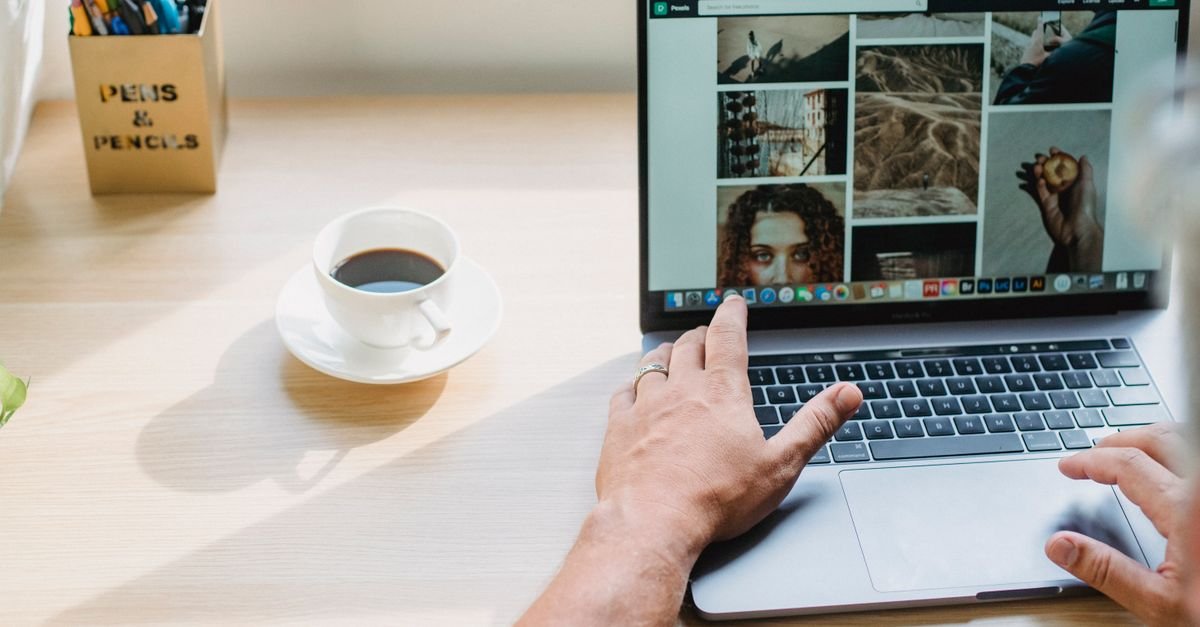 A person browsing an image gallery website with coffee