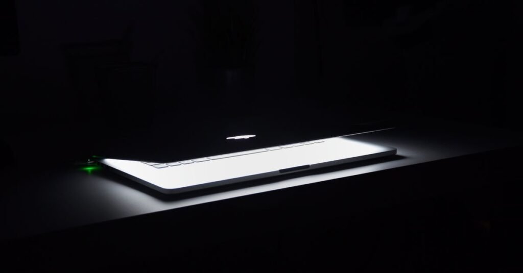 Laptop glowing at night during a website deployment
