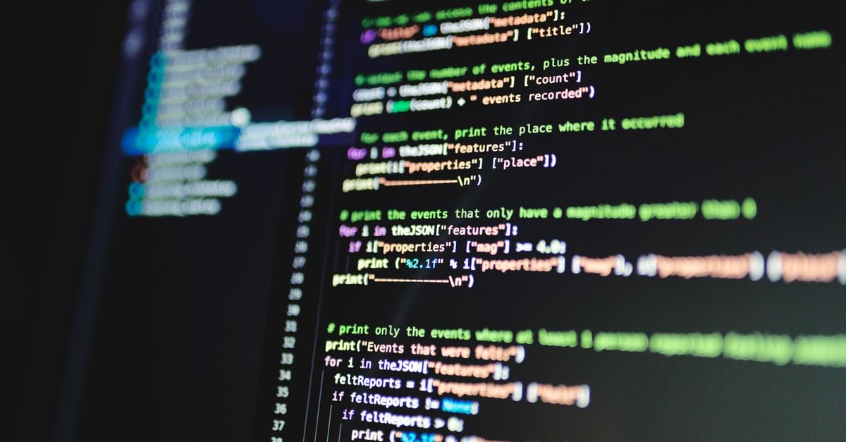Developer working with code on screen