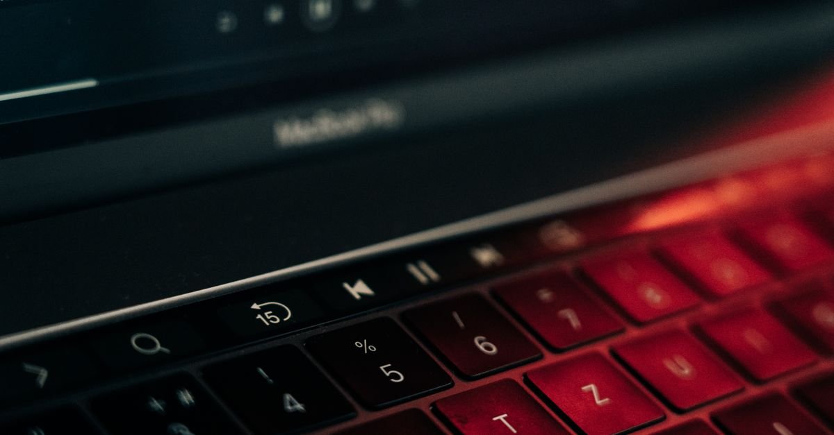 A laptop keyboard in low red light