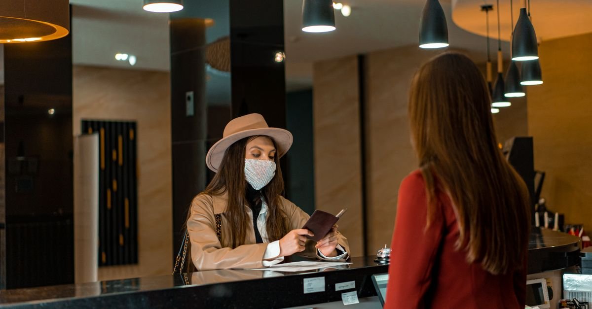 Guests being helped at a reception desk