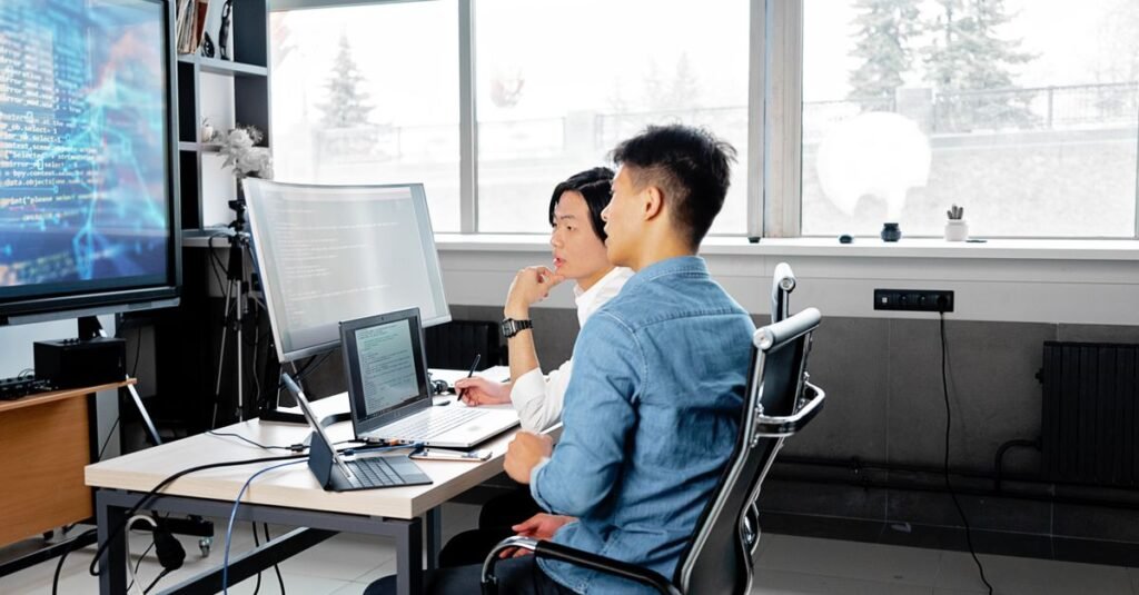 Development team reviewing code together in an office
