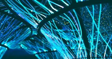 Glowing cyan fiber optic strands against a dark background