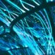 Glowing cyan fiber optic strands against a dark background