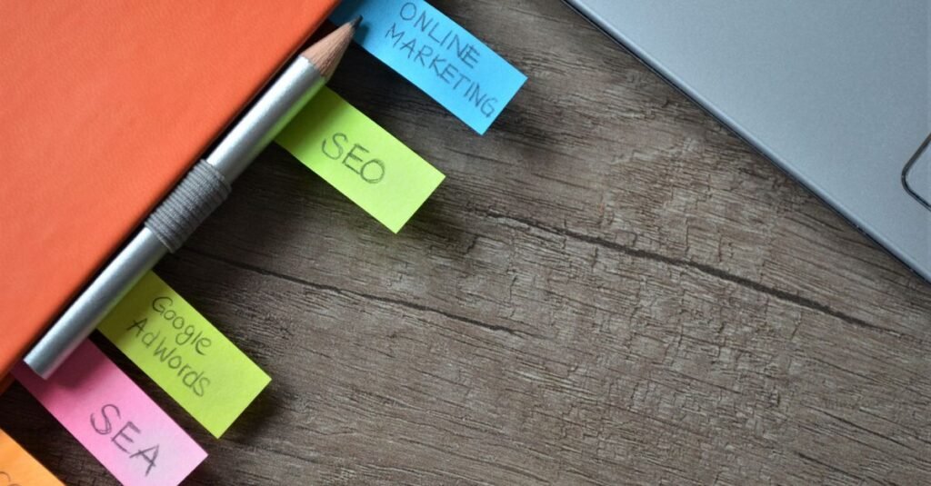 Desk with SEO planning sticky notes and a laptop