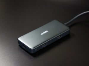 USB-C docking station hub with multiple ports and a connecting cable on a desk