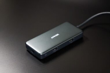 USB-C docking station hub with multiple ports and a connecting cable on a desk