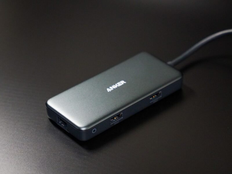 USB-C docking station hub with multiple ports and a connecting cable on a desk