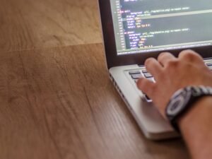 Developer editing website code on a laptop