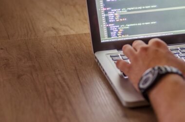 Developer editing website code on a laptop