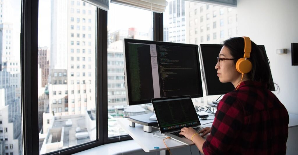 Engineer working at dual monitors