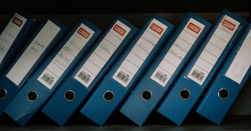 A row of archive binders representing stored records