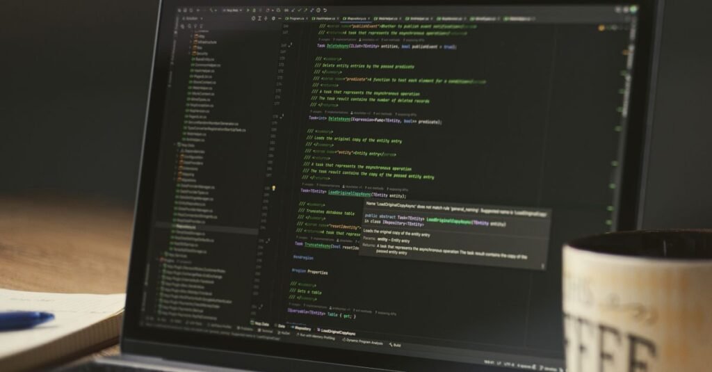 Laptop showing code beside a coffee cup