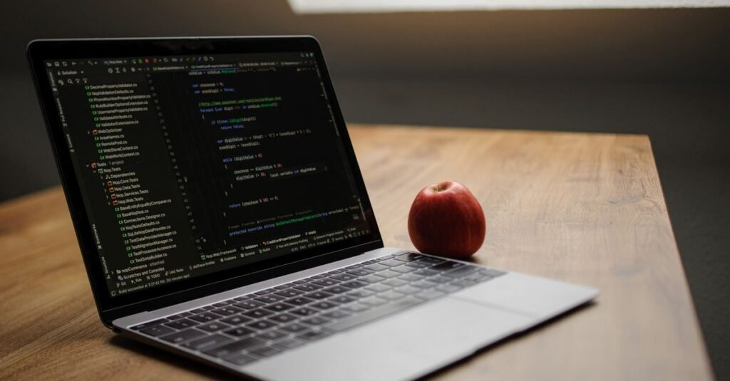 Laptop showing code on a clean desk