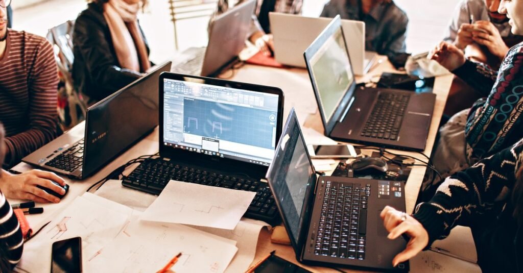 A software team working together with laptops