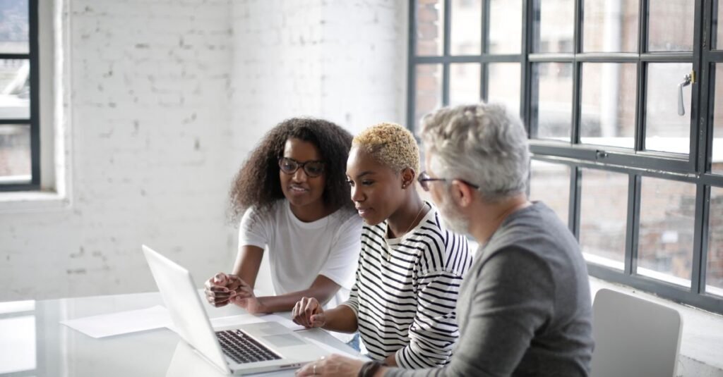 A development team working together at a laptop