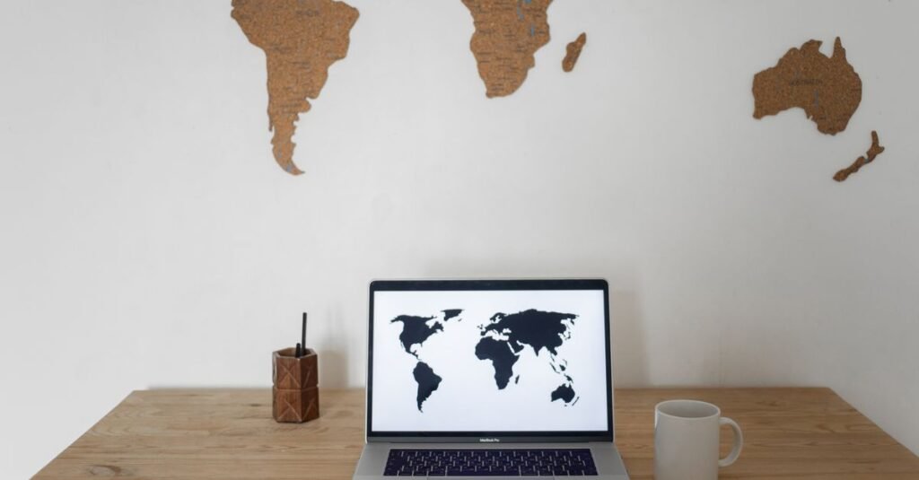 Laptop on a desk displaying a world map